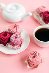 Close up view of delicious pink cupcakes with cup of coffee  on table