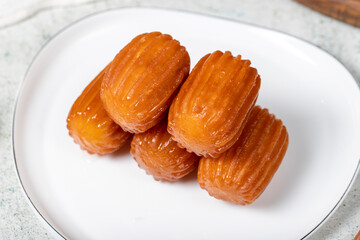 Tulumba dessert. Ramadan sweets. Traditional Turkish cuisine delicacies. Tulumba dessert with syrup on a gray background. Close up