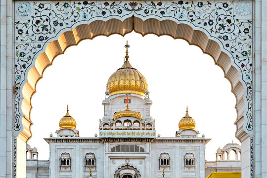 The golden temple of Gurudwara Bangla Sahib Sik is seen through the archway. Delhi. India.