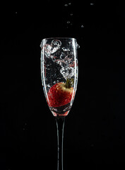 Champaign glass with strawberry black background