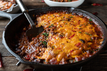 Tex mex stew with beans, ground beef, vegetables and cheddar cheese topping.
