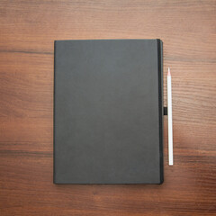 Fototapeta premium Notebook and pencil on a beautiful background in a photo studio