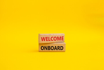 Welcome onboard symbol. Concept words Welcome onboard on wooden blocks. Beautiful yellow background. Business and Welcome onboard concept. Copy space.