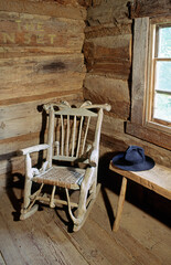 The Museum of Appalachia at Norris, Tennessee, USA. A rocking chair sits in the corner of the log church