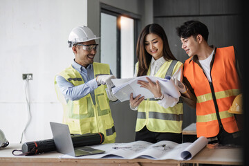 Engineers work as a team with blueprints for architectural plans. Engineer sketching construction project concept with architect equipment Architects talking at table Teamwork and construction concept