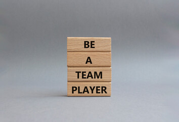 Be a team player symbol. Concept words Be a team player on wooden blocks. Beautiful grey background. Business and Be a team player concept. Copy space