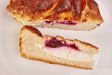 Delicious pie with cheese and cherry jam on a white background.