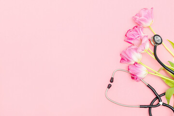 National Doctor's or nurse day greeting card with stethoscope, bunch of tulips flowers on pink...