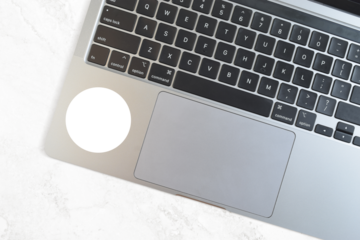 Round Sticker Mockup on Modern Silver Laptop atop Marble Background