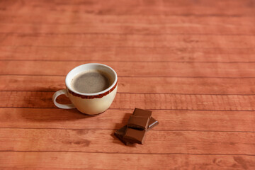 cup of coffee with flowers on wooden background

