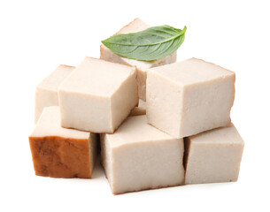 Pile of smoked tofu cubes and basil on white background