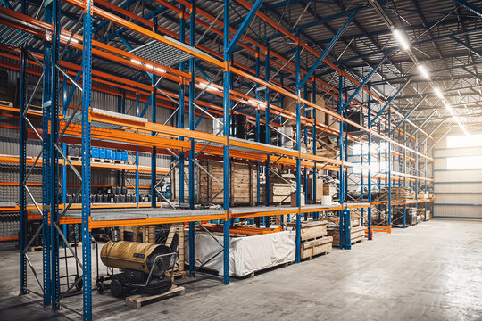 Interior of modern warehouse storage of retail shop. Large industrial warehouse. Tall racks are filled with boxes and containers. Hangar industrial and logistics companies. Shelves with variety of box