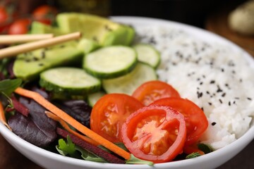 Delicious poke bowl with vegetables, avocado and mesclun, closeup