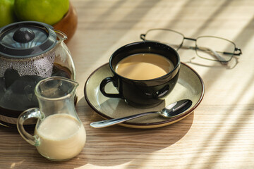 cup of hot Instant coffee dark shot in cup with crema on wooden table and beans . coffee beans and cup full of Intense dark shot coffee in glass cup