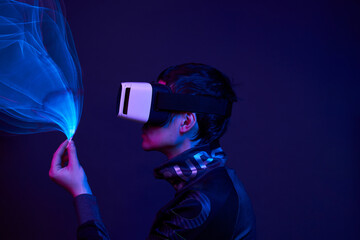 Man is using virtual reality headset to access in metaverse.