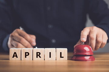 Notification new month has begun, Close up hand ringing the red call bell or service bell ring and...