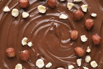 Delicious chocolate paste with nuts as background, top view