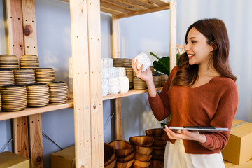 Asian beautiful woman sell handmade vase products online live streaming at home. Young attractive...