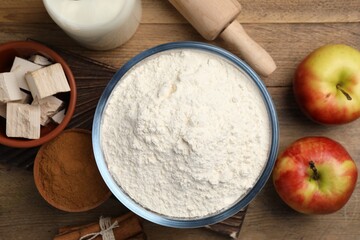 Flour, yeast cake and different ingredients on wooden table, flat lay. Making pie