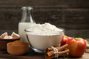 Flour, milk and different ingredients on wooden table. Yeast pastry