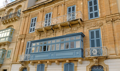 Typical residential houses in Malta with colorful wooden balconies