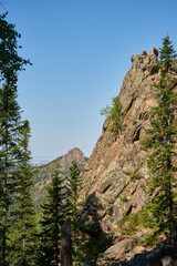 granite Rocks surrounded by coniferous forest. summer in taiga, national park in Siberia