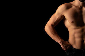 Fototapeta na wymiar the torso of a young athletic guy. concept: the male body after exercise and diet. men's health: shaved breasts on a black background