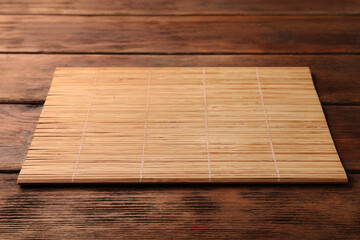 Bamboo mat on wooden table, space for text
