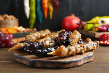 Many delicious sweet churchkhelas on wooden table