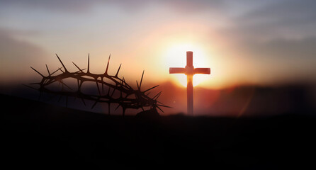 The sunset sky, the cross symbolizing the suffering and resurrection of Jesus Christ, the crown of...