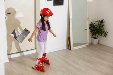 little girl is roller skating at home