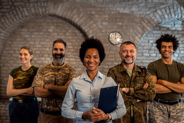 Portrait of smiling diverse veterans at PTSD support group.