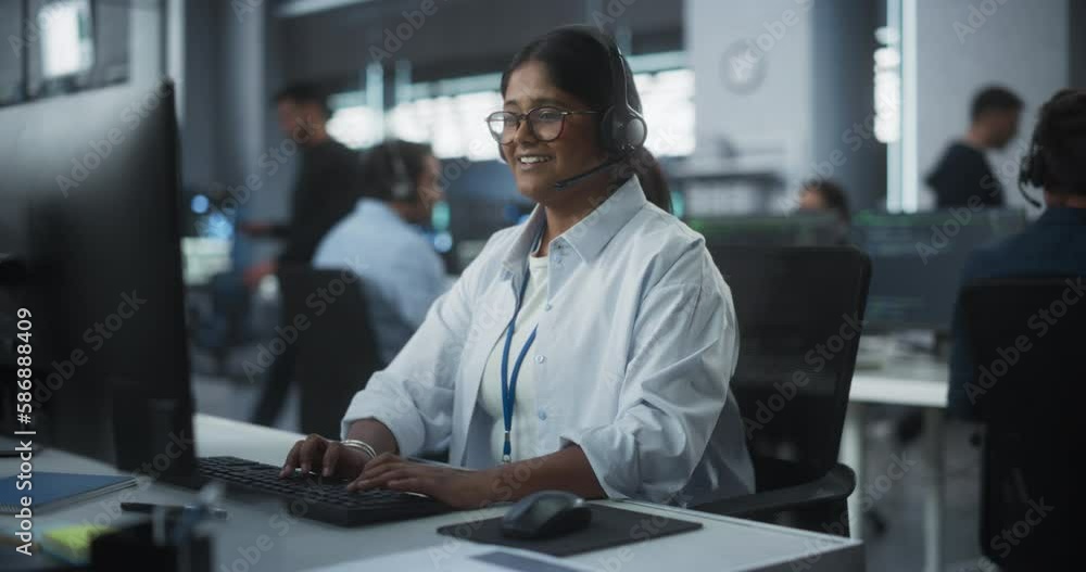 Fototapete Help Desk Specialist Answering a Call, Providing Technical Support to Client Experiencing Computer Hardware and Software Issues. Indian Female Using a Headset to Have a Conversation with a Tech Team