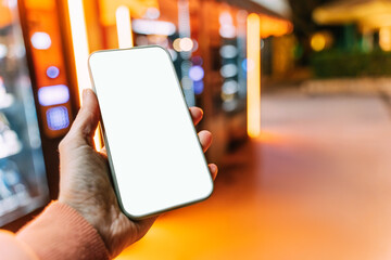 Close-up smartphone with blank display in male hand.