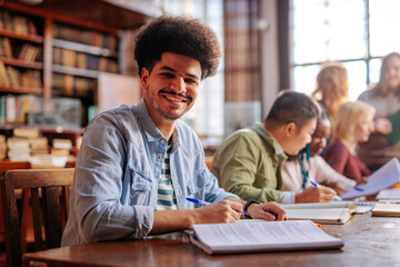 Joyful student in library.