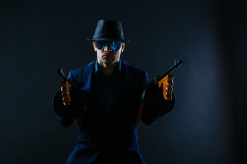 Mature Business Man Holding Gun on a dark background