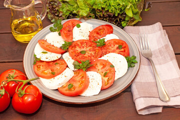 Tomato and mozzarella Caprese salad with sauce 