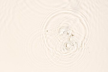 Water surface abstract background texture with splashes and bubbles. Beige color