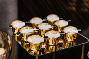 Candy bar for banquet. Plate with sweets, and candies. Delicious wedding reception. Celebration birthday concept. Trendy desserts.  Close up. Top view. Candy bar with desserts for celebrating baptism.
