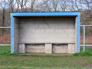 The dug out beside an amateur soccer pitch ready for the team coach, trainer and substitutes
