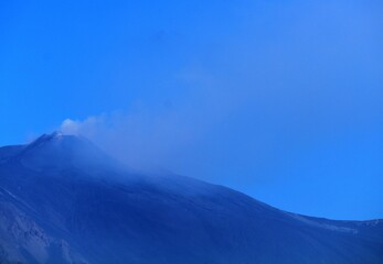 evocative image of the Etna volcano in Sicily with a blue sky
