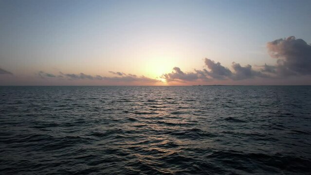 Flying over the waters of the Gulf of Mexico at Sunset. Located in Cancun, Mexico. Aerial 4K drone video