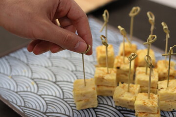 Hand of a man taking food from a catering