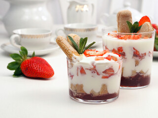 Dessert with mascarpone and whipped cream, savoiardi biscuit and fresh strawberry