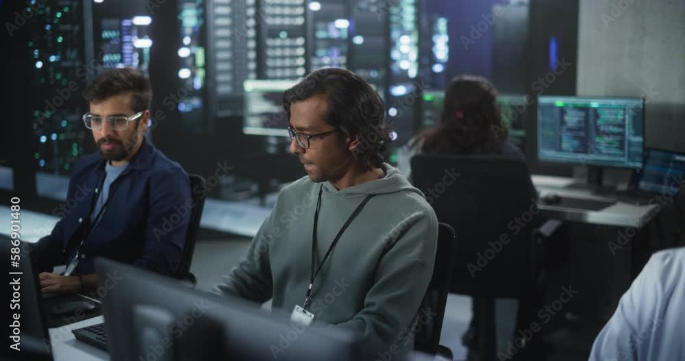 Poster Young Team of South Asian Specialists Working on Computers and Having a Conversation at a Workplace. Two Male Software Developers Discussing a Solution for Their Artificial Intelligence Project