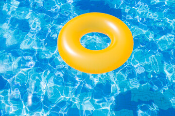 inflatable pool with swimming ring and rings in a water on blue background in the summer day.
