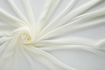 Beautiful white tulle fabric as background, top view
