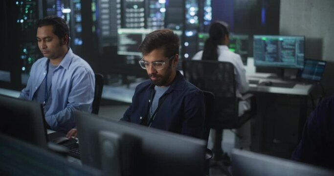 Portrait of a Handsome Indian Engineer Working on Desktop Computer in a Technological Office Environment. Research and Development Department Writing Software Code for an Innovative Internet Project