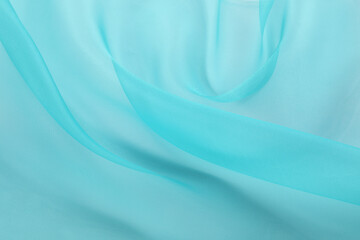 Obraz premium Beautiful turquoise tulle fabric as background, closeup
