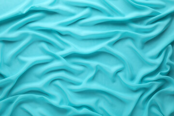 Beautiful turquoise tulle fabric as background, top view